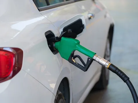 A fuel nozzle in the filler of a white car