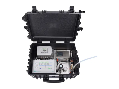 A portable air quality measurement kit in an open case, with particle, oil vapour and dew point instruments and a sample connection