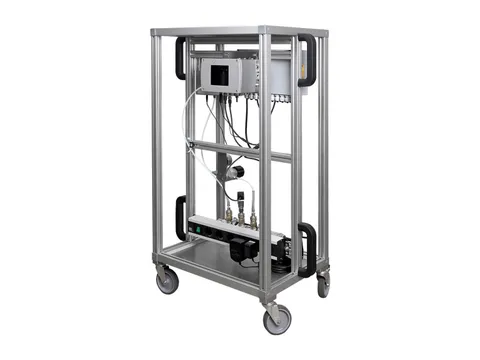An air quality measurement station on a wheeled aluminium frame, with its display and sampling connections
