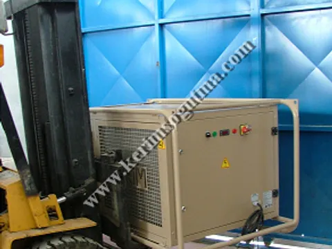 A tent air conditioner in its carrying frame being moved by a forklift