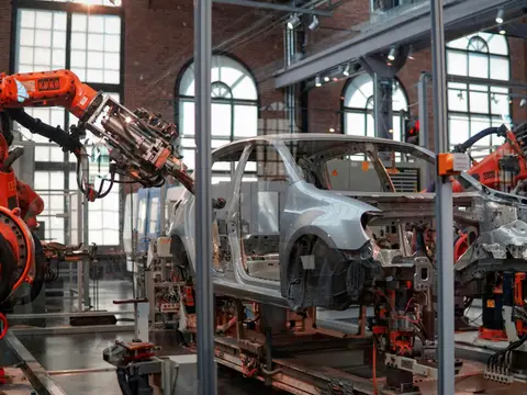 Robots welding a car body on an assembly line